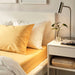 IKEA NATTJASMIN Yellow Pillowcase on a Bed 90543470