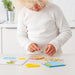 Children arranging colorful beads from the IKEA children bead set, promoting hand-eye coordination and spatial awareness.   60316073