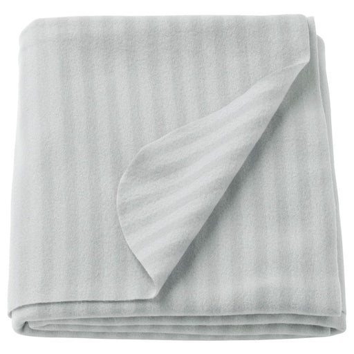 Folded light gray fleece blanket with a subtle striped pattern, soft and cozy texture, ideal for home or travel use.-70304890
