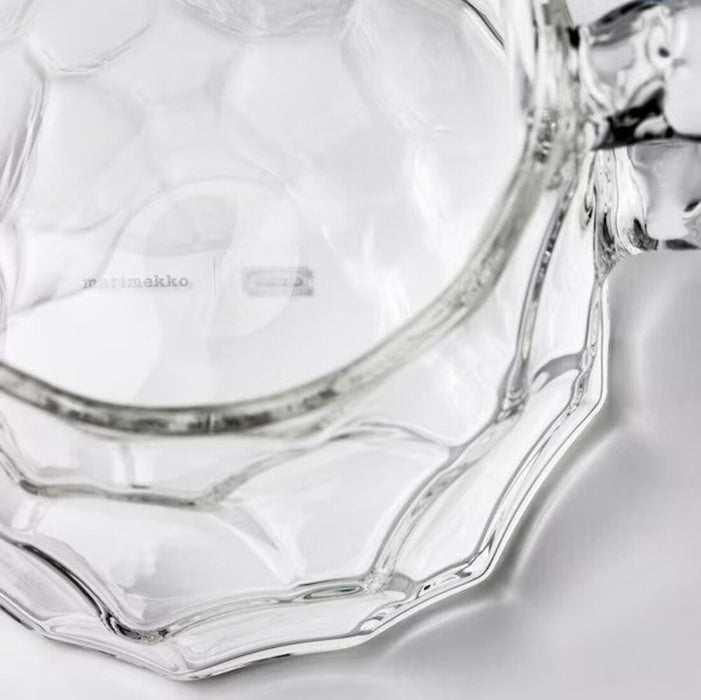 Clear glass jug with a sleek design and sturdy construction, perfect for serving drinks at home or any occasion.