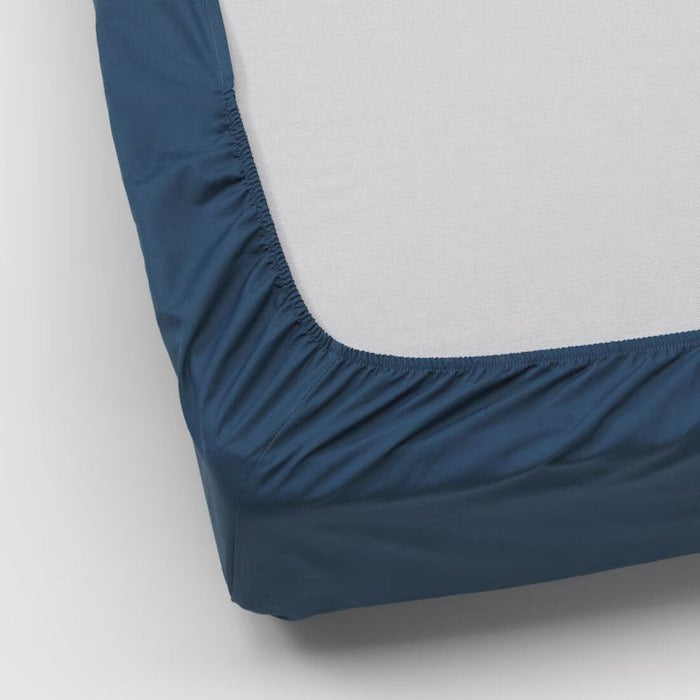 Close-up of the IKEA ULLVIDE dark blue fitted sheet's texture and stitching.  90342725
