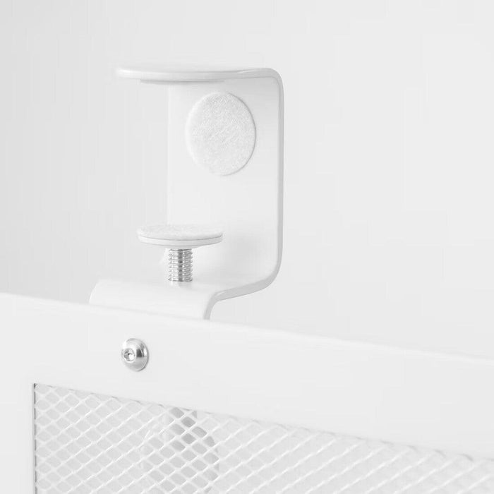 "The image shows a close-up view of a white cable management tray, specifically focusing on the mounting mechanism. The tray is attached using a clamp that has a screw mechanism for tightening. The clamp has a felt pad on the top and bottom to protect the surface it is attached to. The tray itself has a mesh design for ventilation and organization. This image is relevant as it highlights the secure and protective mounting system of the cable management tray, which is important for users looking to organize 