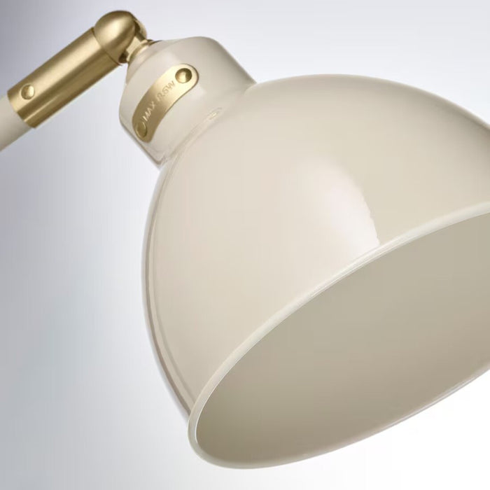A light beige IKEA RÖDFLIK desk lamp with a vintage industrial design, featuring a glossy enamel-like finish, brass-colored accents, an adjustable shade with a toggle switch, and a sturdy base—ideal for focused workspace lighting.20583921   