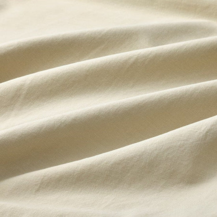 A close-up shot of IKEA's duvet cover in a soft light beige-green with a matching pillowcase -70490806