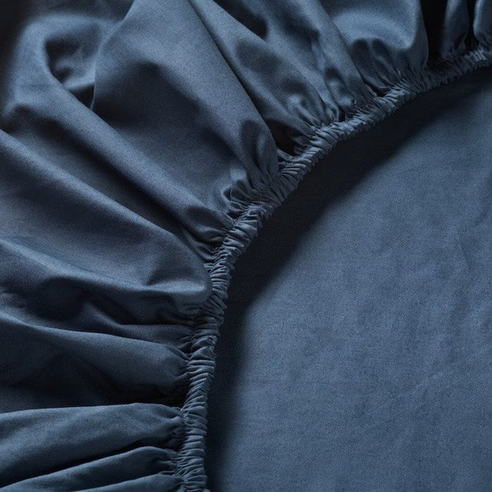 Detailed close-up image of the dark blue fitted sheet's fabric and design from IKEA ULLVIDE. 90342725