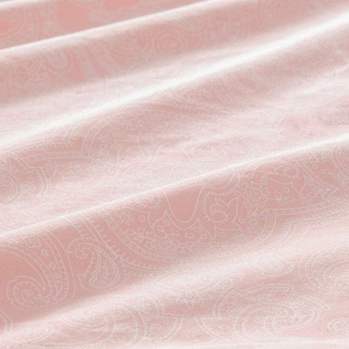 A close-up shot of IKEA's duvet cover in a softlight pink/white with a matching pillowcase 
