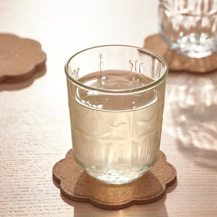 A patterned cork coaster from IKEA, measuring 10 cm (4 inches), ideal for preventing drink stains on your furniture--30550816