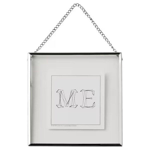 IKEA LERBODA silver metal hanging frame, 16x16 cm, with a chain for wall mounting. Minimalist home decor frame with a clear glass front and a geometric typography print inside.40516308