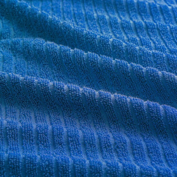 An image of an IKEA washcloth inbright blue. The cloth is draped over a towel rack, and its soft texture and absorbent properties are visible.