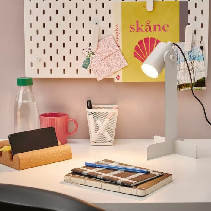 The FLOTTILJ Desk Lamp illuminating a workspace with its bright LED light -70552314