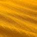 Close-up view of a textured, golden-yellow IKEA VÅGSJÖN washcloth, 30x30 cm, highlighting its soft and absorbent surface.90549518

