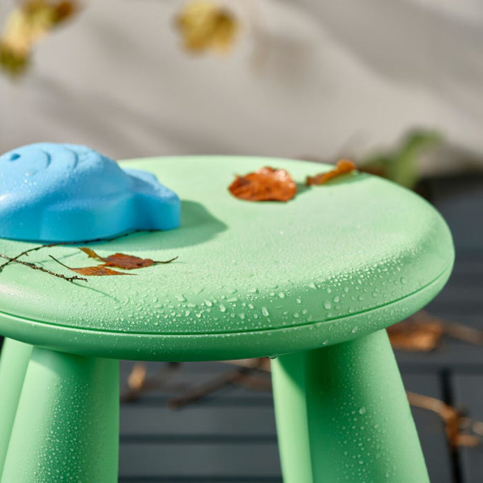 A cheerful light green IKEA MAMMUT stool sized for kids, great for crafts, picnics, or tiny feet needing a boost 00586609
