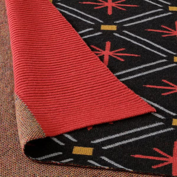 Close-up of the Red/Black VINTERFINT Throw's Textured Fabric