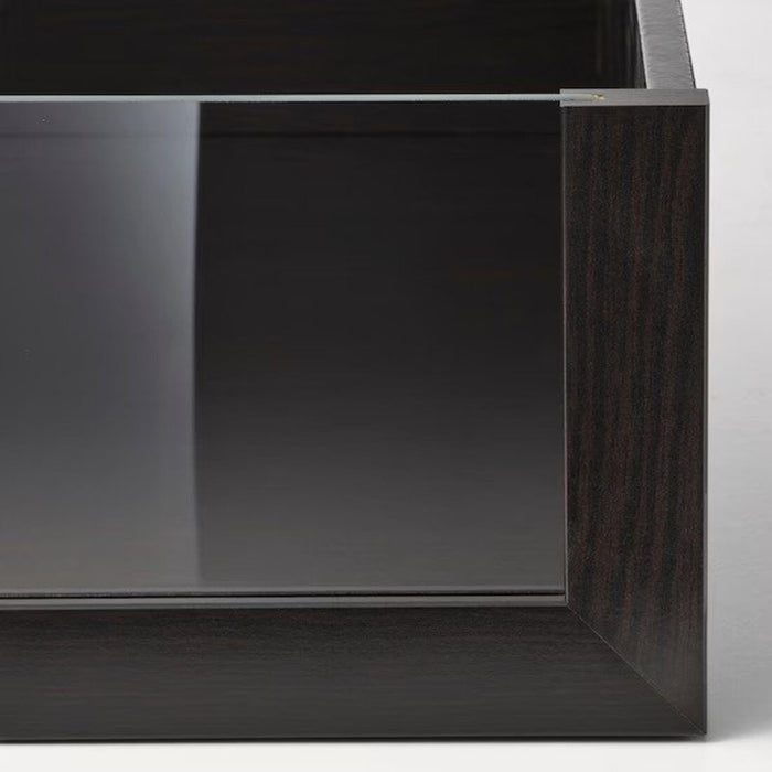 A space-saving black-brown drawer with a glass front, suitable for small apartments.
