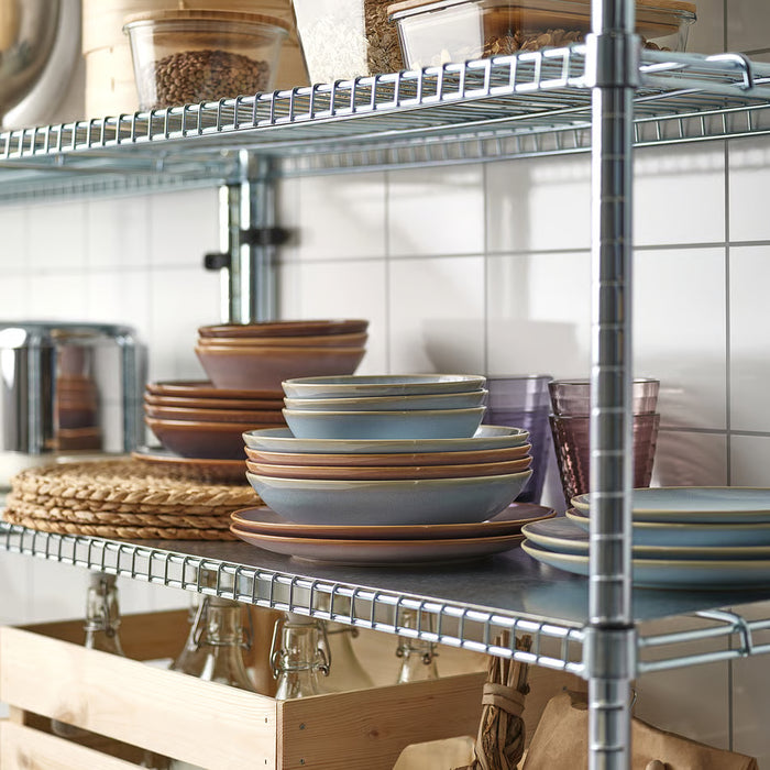 Wire kitchen shelf styled with FÄRGKLAR plates, bowls, jars and wooden crates