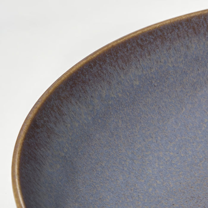 Close-up of IKEA FÄRGKLAR lilac deep plate showing textured reactive glaze rim