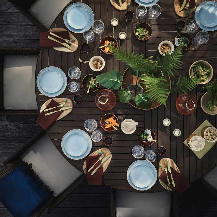 IKEA FÄRGKLAR light blue dinnerware set styled on wooden table with greenery and placemats