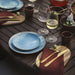 IKEA FÄRGKLAR light blue plates styled on wooden dining table with cutlery and wine glasses