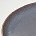Close-up of IKEA FÄRGKLAR lilac plate edge showing glossy speckled glaze detail