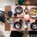 IKEA FÄRGKLAR lilac plates styled on dining table with matching bowls and cups