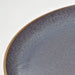 Close-up of IKEA FÄRGKLAR lilac plate showing textured glazed surface and smooth edge