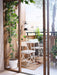  IKEA FEJAN white outdoor table and chairs on wooden deck with green plants sliding doors