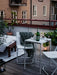 IKEA FEJAN white outdoor table styled on modern balcony with plants and lantern