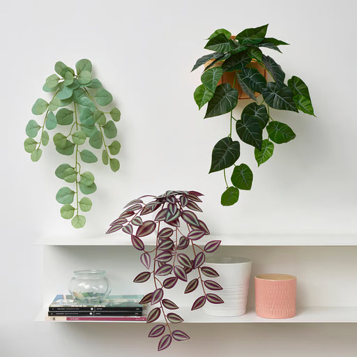 Three IKEA FEJKA lifelike artificial plants decorating white wall shelves indoors