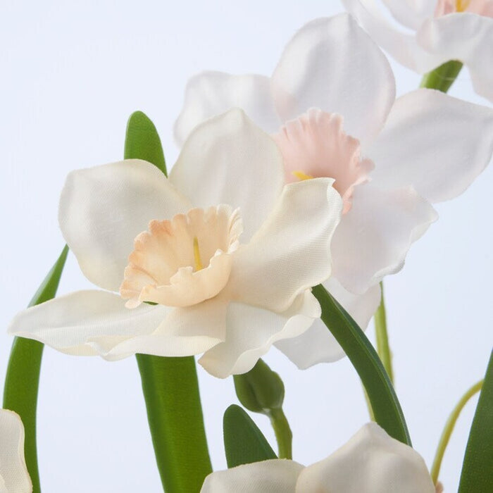 Detailed view of lifelike white daffodil blossoms on the IKEA FEJKA Artificial Potted Plant