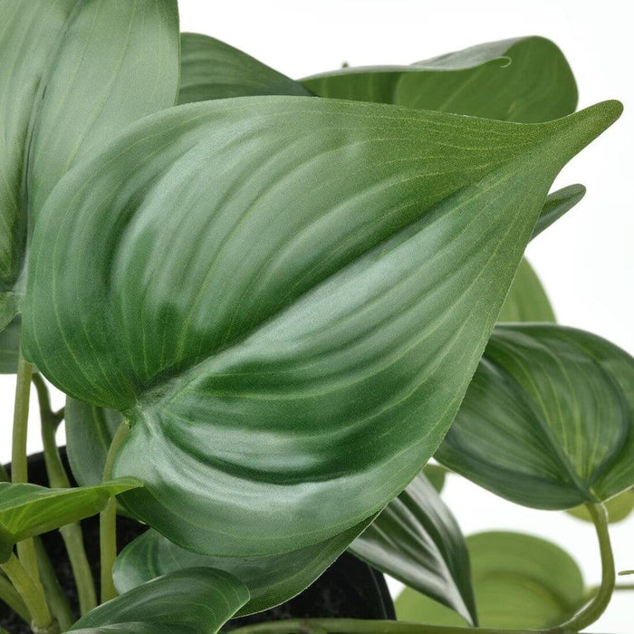 "Artificial Golden Pothos plant by IKEA, designed for both indoor and outdoor use. The plant features long, trailing vines with heart-shaped, glossy green leaves that have lighter green veins, giving them a realistic appearance. It comes in a 12 cm (4 ¾ inch) diameter black pot-50578070    