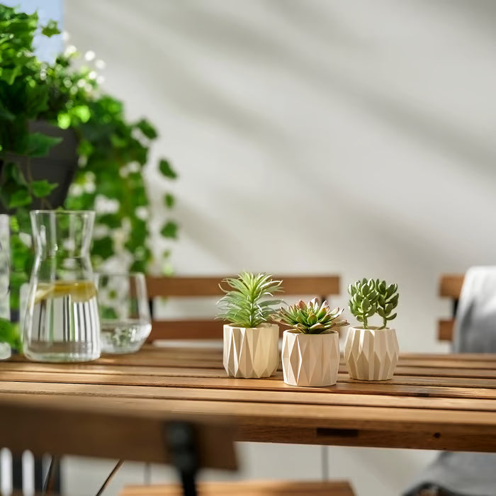 Close-up of IKEA FEJKA artificial succulents showing lifelike leaf detail and texture in white pots