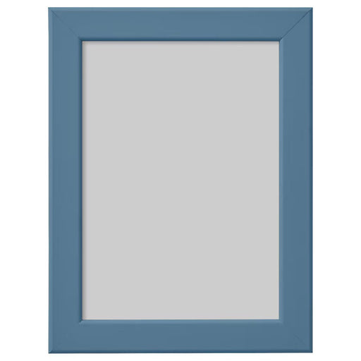 Modern IKEA FISKBO frame in dark grey-blue, standing on a desk with a photo inside
 80584927