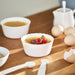 IKEA FISKTÄRNA white ramekins with custard and berries alongside milk and eggs