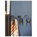 IKEA FJÄNTIG black chair hooks on wall holding polka dot fabric in home setting
