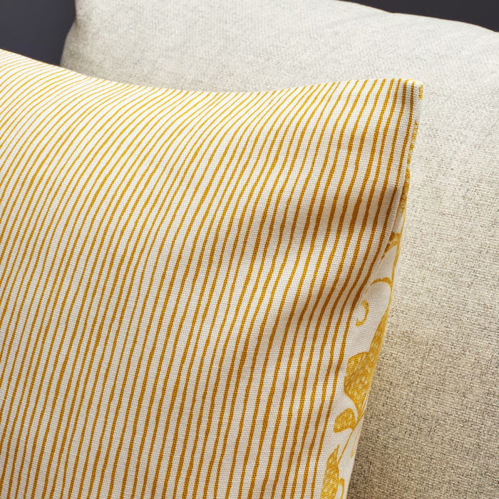 Close-up of IKEA FJUNKLOCKA cushion cover showing foliage and stripe reversible sides with visible stitching