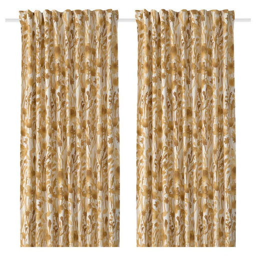 A pair of IKEA FLENTIMOTEJ curtains in light beige with a floral pattern. Each curtain panel measures 145x250 cm and is shown hanging from a curtain rod. The floral design features various shades of beige, brown, and cream, adding a subtle decorative touch to the light beige background. The curtains are displayed against a white backdrop, highlighting their design and color.