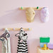  IKEA FLISAT knob rack installed in hallway holding kids cap and bag
