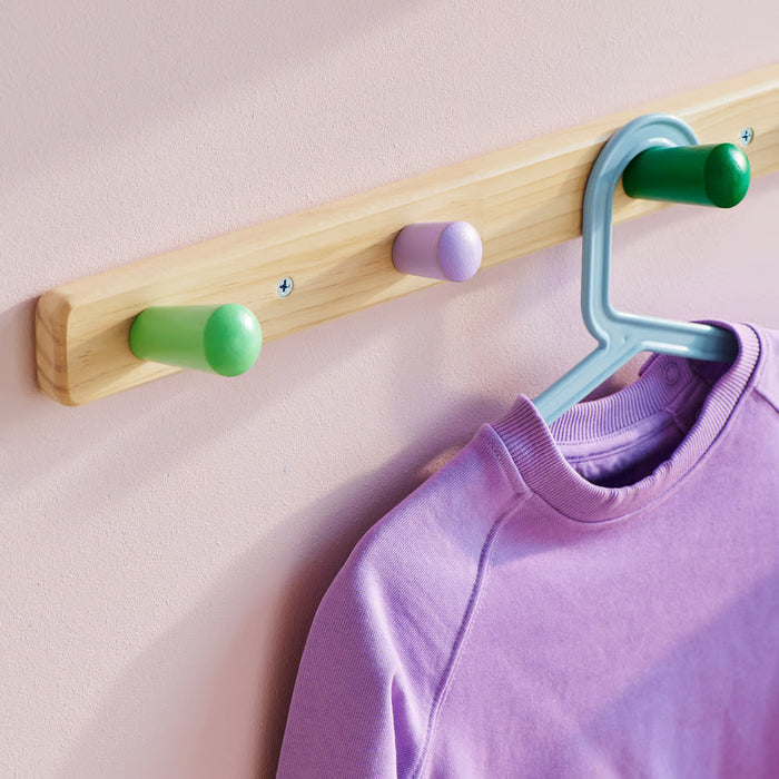 Close-up of IKEA FLISAT cone-shaped wooden knobs in multiple colours