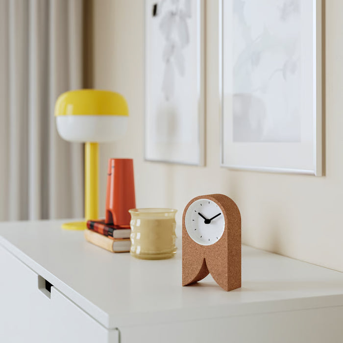 IKEA FLODKRÄFTA cork clock on study desk beside lamp and books minimalist home office setting