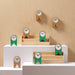 IKEA FLODKRÄFTA cork clock in natural and green variants displayed together in wooden tray