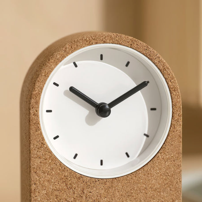 Close-up of IKEA FLODKRÄFTA cork clock white face with black hands no ticking quartz movement