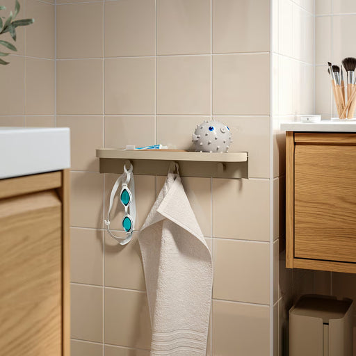 IKEA FLORSJÖN beige shelf with hooks mounted in a bathroom above washbasin side view