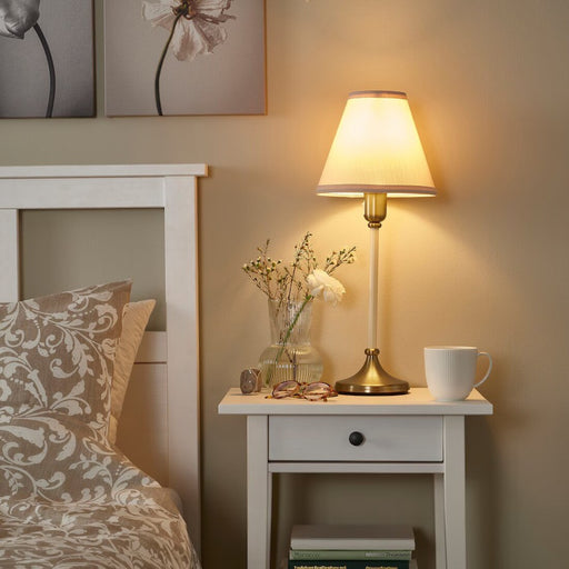 "Stylish IKEA bedside table lamp with soft, warm light-70524458
