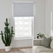 Modern living room with IKEA FÖNSTERBLAD white blind on large window grey sofa and wooden floor