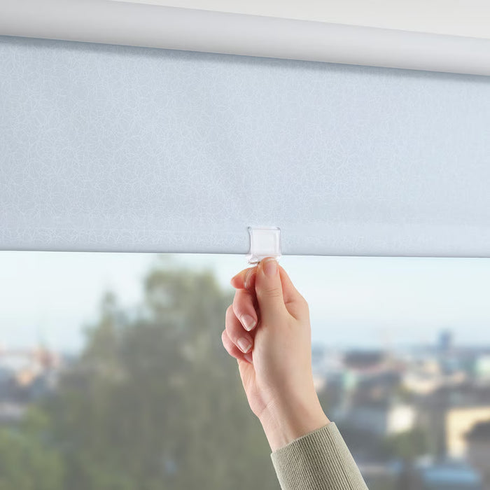  Hand adjusting IKEA FÖNSTERBLAD cordless white roller blind showing smooth silent operation