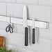IKEA FÖRDUBBLA grey kitchen knives stored on a wall-mounted knife rack alongside scissors