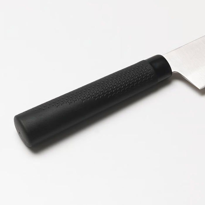 Close-up of IKEA FÖRSLAG knife showing black textured non-slip handle and polished stainless steel blade