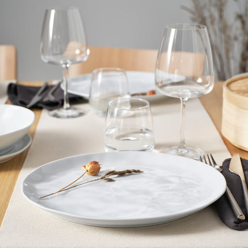 IKEA FORELLTETRA white porcelain plate with glasses and dried flower on a dining table