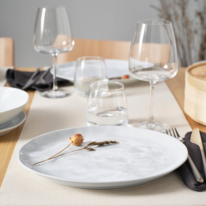 IKEA FORELLTETRA white porcelain plate with glasses and dried flower on a dining table