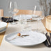 IKEA FORELLTETRA white porcelain plate with glasses and dried flower on a dining table
